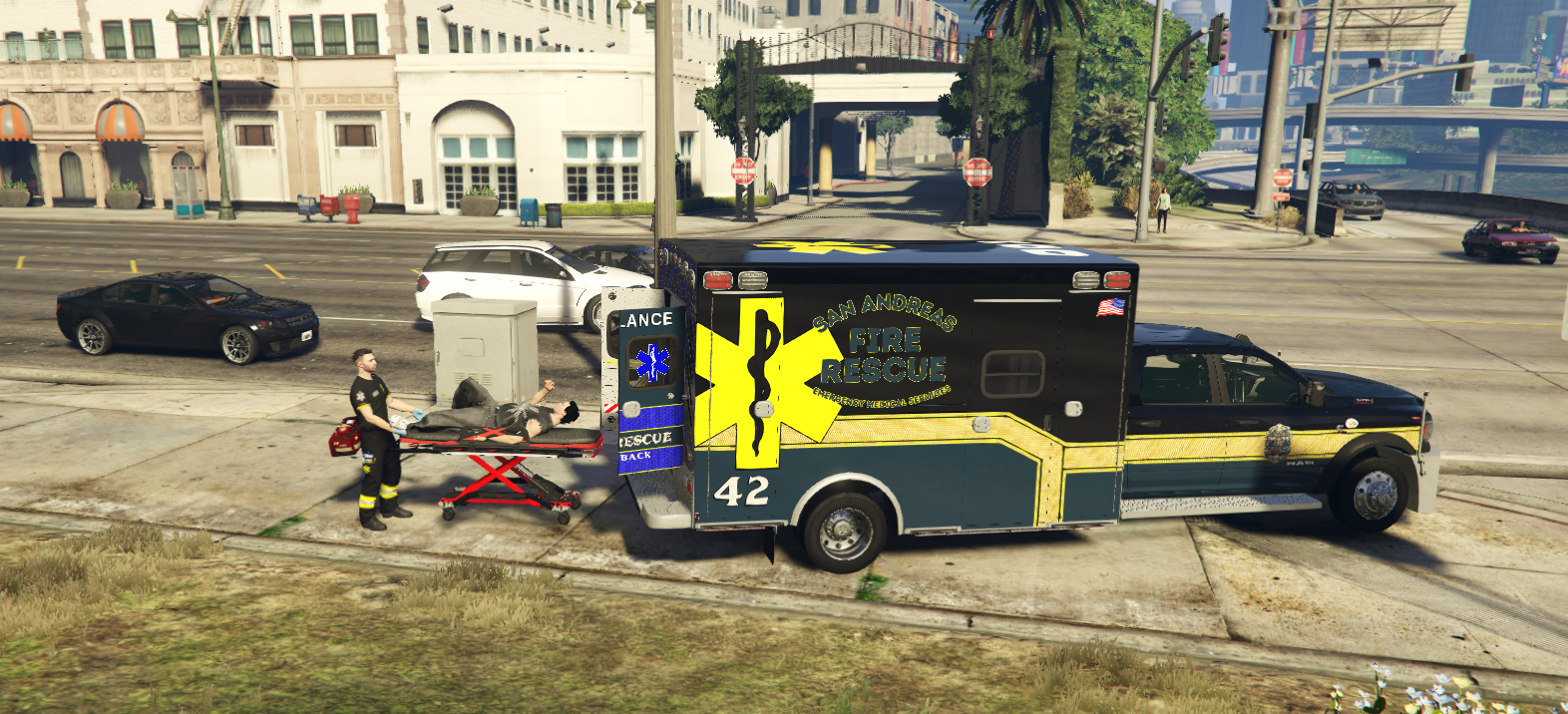 EMS personnel providing patient care beside an ambulance